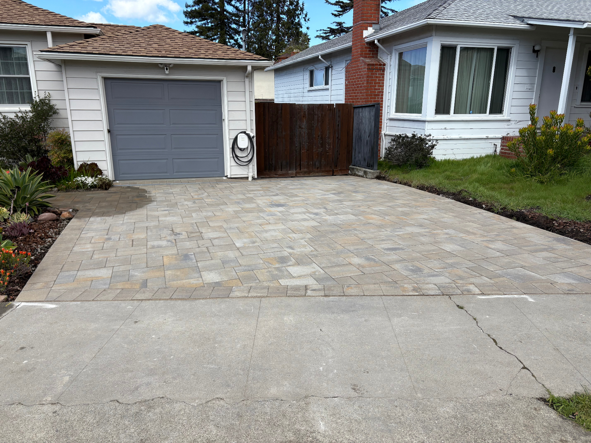 Completed Belgard driveway project with gray border and wide layout